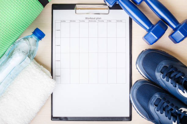 Personal workout plan with sneakers and dumbbells