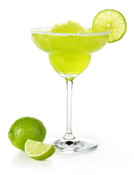 Photo of frozen margarita garnished with lime isolated on white