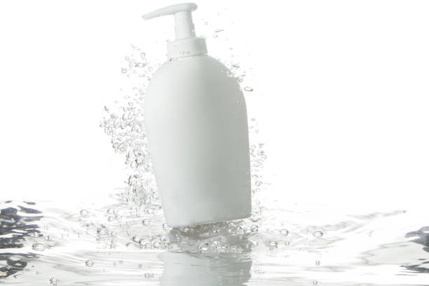 liquid soap dispenser and bubbles over rippled water