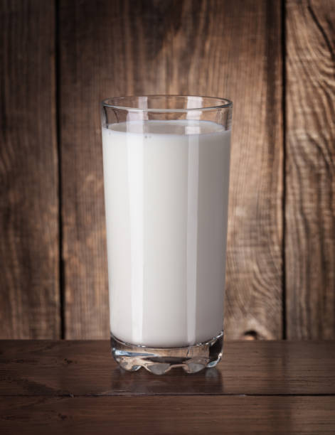 istock Fresh milk in a glass on old boards 648445924