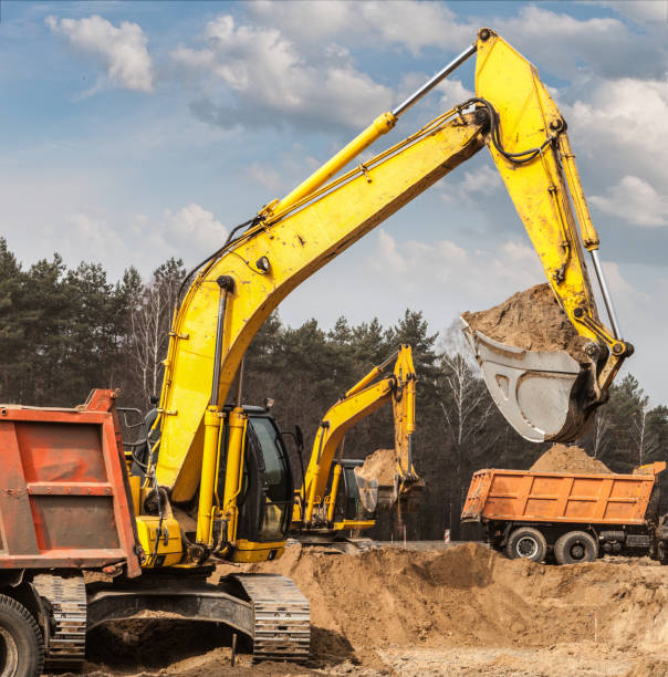 istock Excavators ship sand in trucks on road construction 648446078