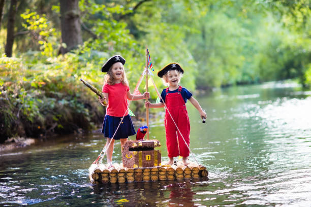 istock Kids playing pirate adventure on wooden raft 648455884