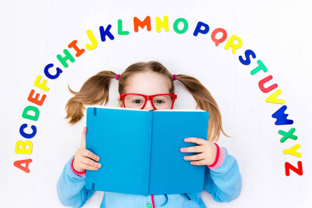 istock Child learning letters of alphabet and reading 648455962