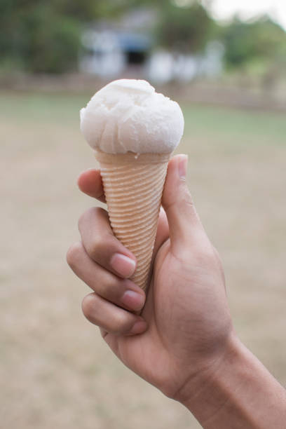 istock Hand holding ice cream, Summer heat freshness. 648470920