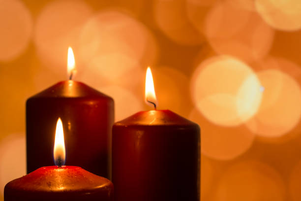 istock Candles with flames at reflectiv advent season 648473718