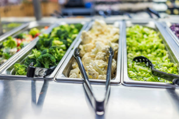 istock Broccoli, cauliflower and celery in salad bar counter 648477356