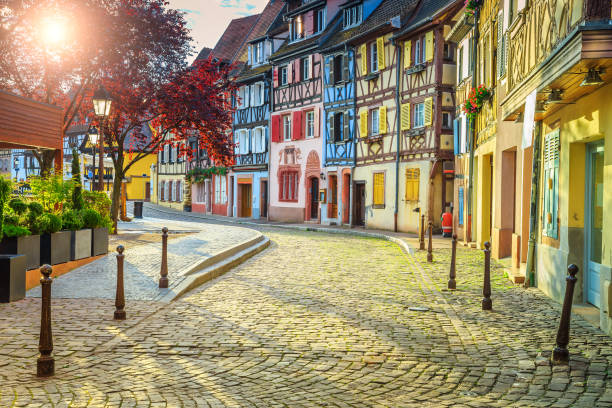 istock Colorful medieval half-timbered facades with paved road in Colmar 648477632