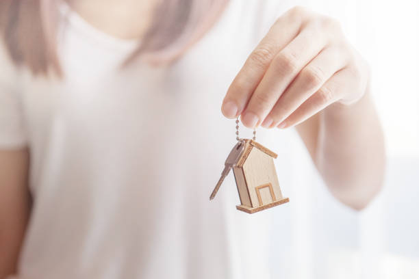 istock Female hand holding house key 648488836