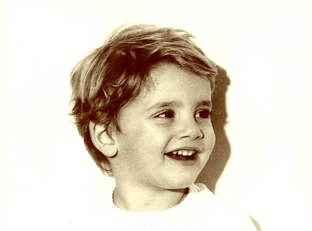 istock Cute child smiling - grainy black and white 648489412