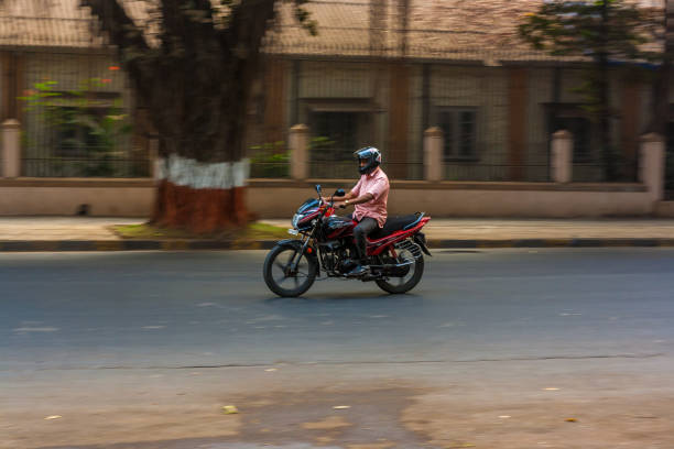 A traditionally dressed man rides a motorcycle through a Kolkata street during the morning rush, captured with a motion blur effect that highlights speed, movement, and the rhythm of city life.Bus at  Kolkata street during the morning rush, captured with a motion blur effect that highlights speed, movement, and the rhythm of city life.