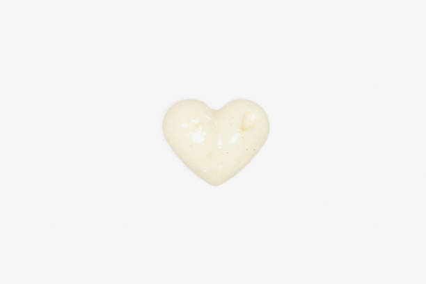 istock Close Up Of A White Chocolate Piece Having A Heart Shape 648497988