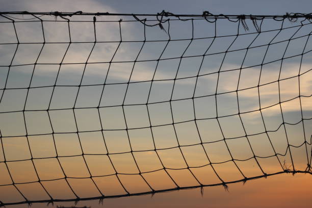 istock Old net for beach volleyball on sea coast on sunrise 648498788