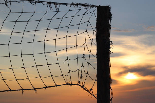 istock Old net for beach volleyball on sea coast on sunrise 648499182