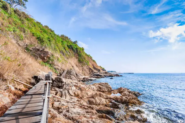 Beautiful seascape with rocks and meadow in cloudy blue sky at Khao Leam Ya National Park, Rayong province Thailand