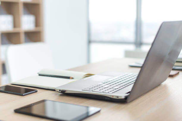 istock Workplace with notebook laptop Comfortable work table in office windows and city view. 648500646