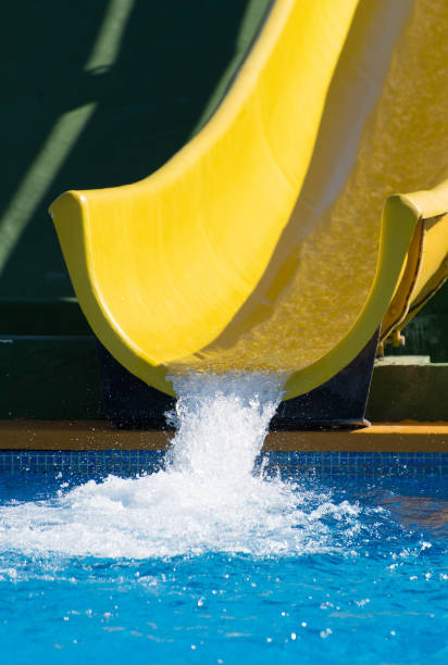 istock Yellow plastic water-slide in aqua park. 648501102