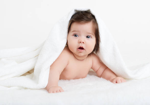 istock Baby lie on white towel. Child in bed. 648509802