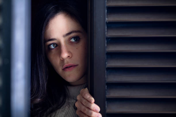 istock Worried Woman at Window 648510120