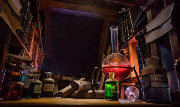 Medieval alchemist laboratory with various kind of flasks and old books in Prague, czech republic