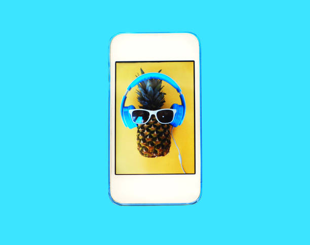istock Fashion pineapple on screen smartphone over colorful blue background 648521024