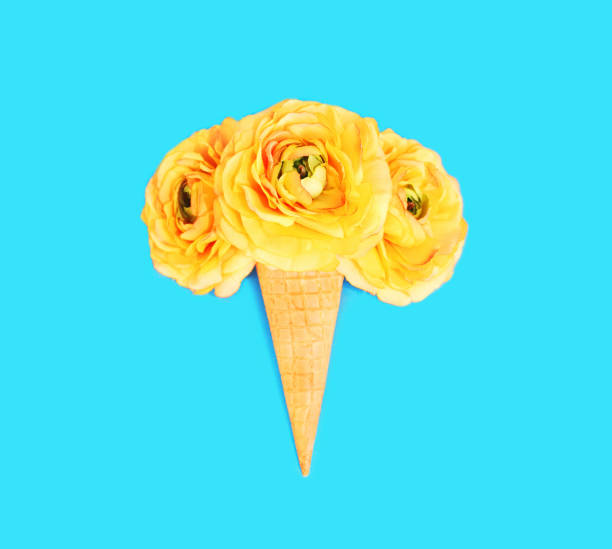 istock Ice cream cone with flowers over colorful blue background top view 648521100