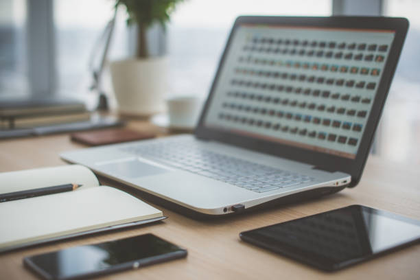 istock Workplace with notebook laptop Comfortable work table in office windows and city view. 648526294