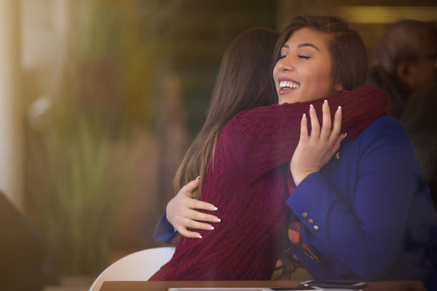 istock Two Friends Greeting Each Other in a Cafe 648533586