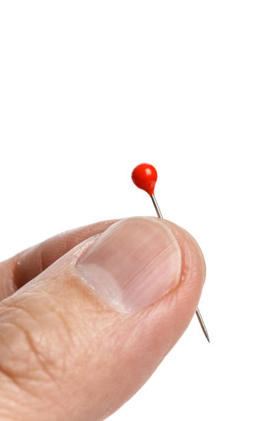 istock hand holding a pin with a red head 648543248