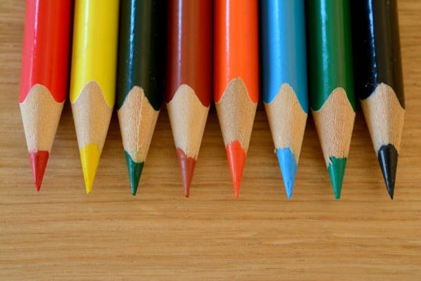 istock Coloured pencils on wooden table closeup. 648544466