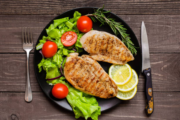 istock Grilled chicken breast fillet served with herbs, vegetables and 648550654