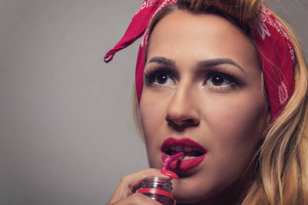 istock Pin up Blonde girl retro style drinking using straw 648551056