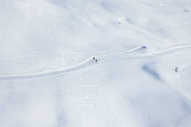 istock Two skiers running on the snowcapped mountains 648557742