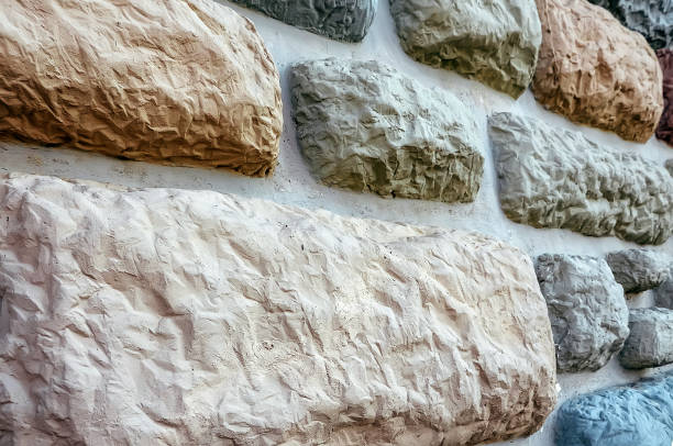 istock decorative wall, which is built from river pebbles and cement. Exterior view of the building 648564362