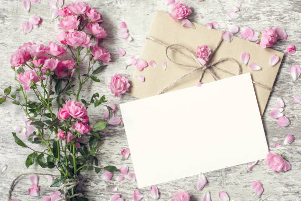istock Blank white greeting card and envelope with pink rose flowers 648568062