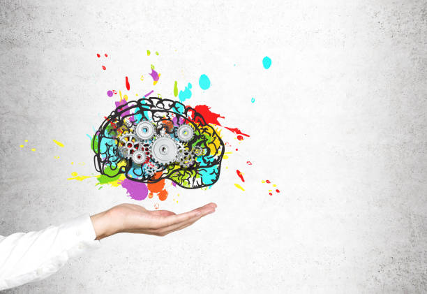 istock Close up of man hand with brain, gears, concrete 648568628