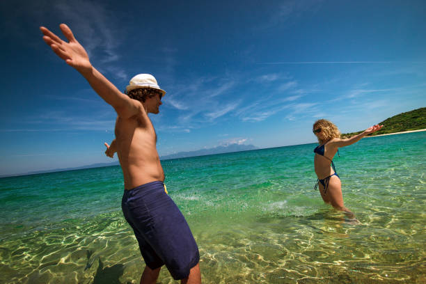 istock Young couple lying on the beach, sunbathing and enjoying summer sun 648579066