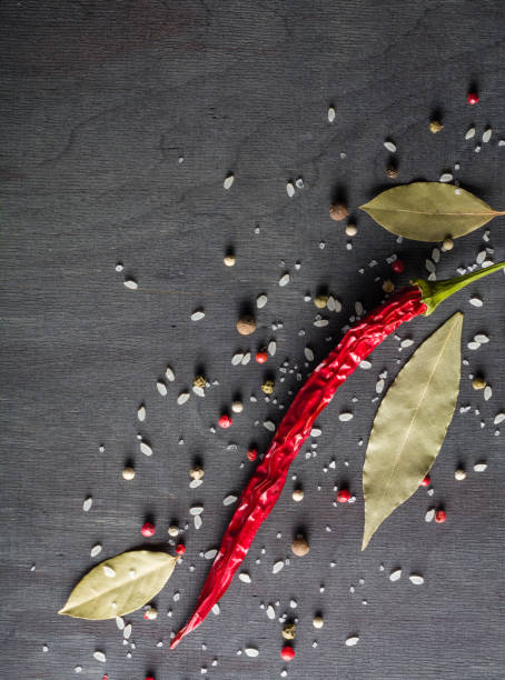 istock Red pepper pungent spices and bay leaf on the black tree. View from above. 648585914