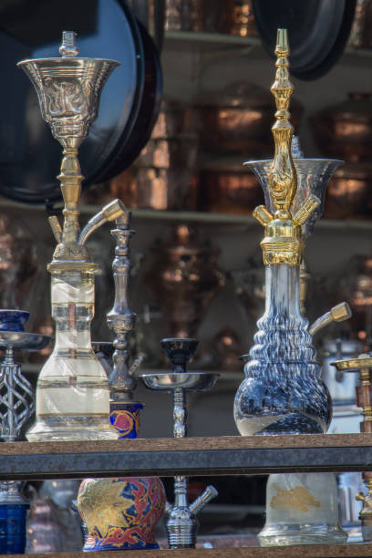 istock Group of eastern hookahs of various colors on a shelf 648592422