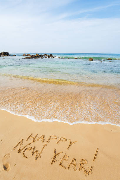 istock Happy New Year text on the sea beach. 648594742