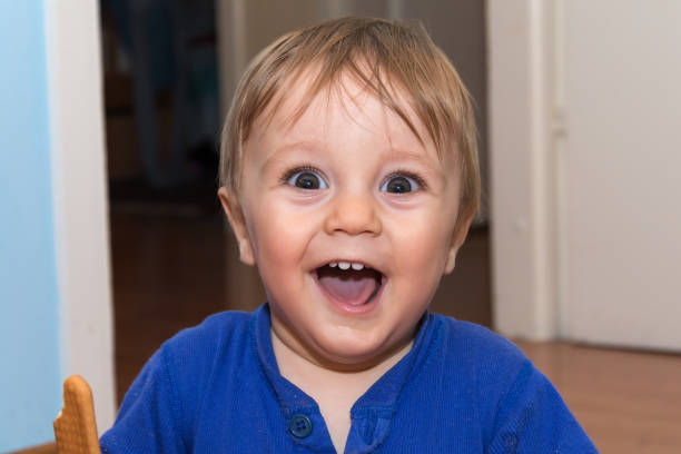 istock Cute baby is eating snack 648596720