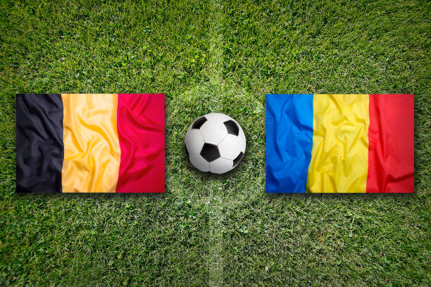 Belgium vs. Romania flags on a green soccer field