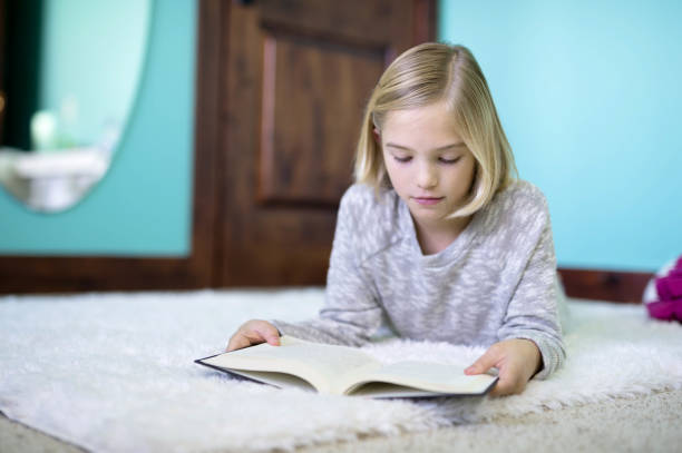 istock Girl reading on floor 648605946