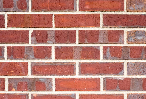 istock Red Brick Wall with Gray Weathering Closeup 648630252