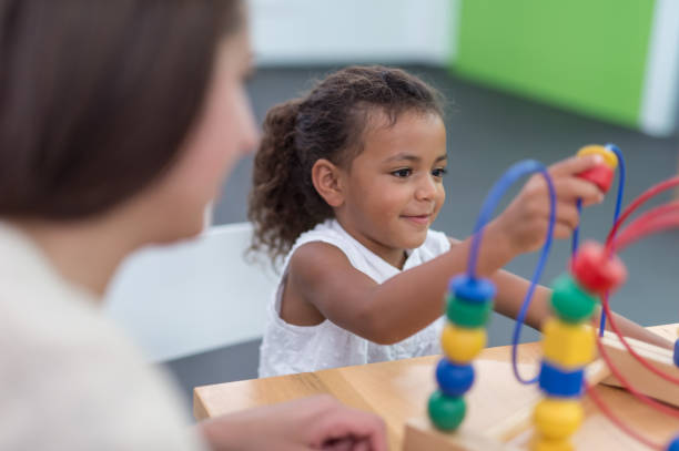 istock Therapist doing play therapy with young girl 648636236