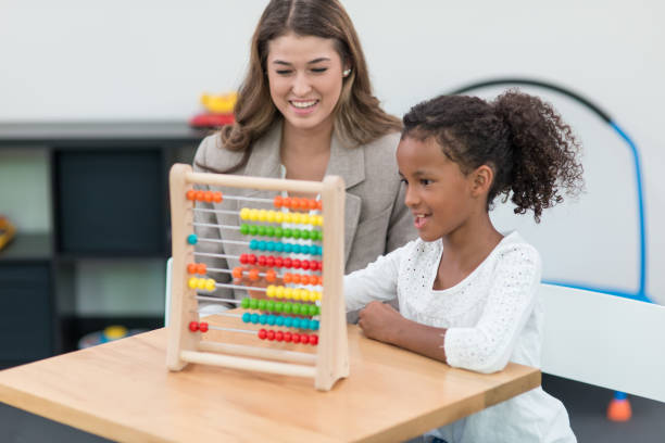 istock Therapist doing play therapy with young girl 648636266