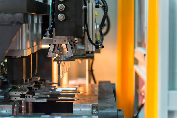 istock The operation of PET bottle blowing machine 648636406