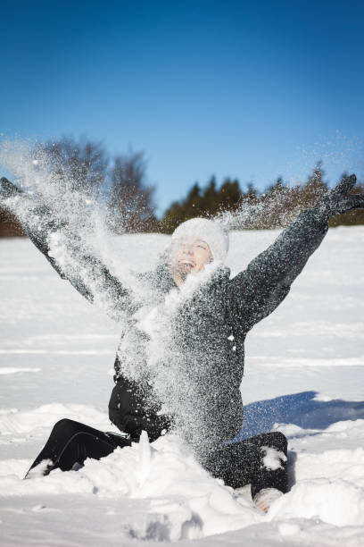 istock Beautiful woman playing with snow 648646286