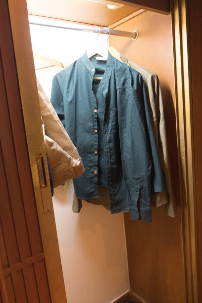 istock Man dresses hanging in wooden wardrobe 648652930