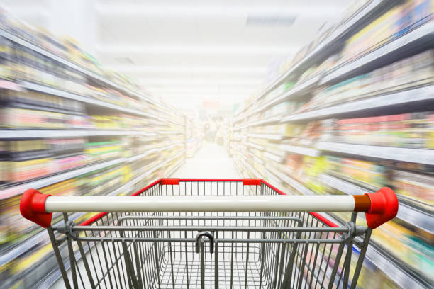istock Supermarket aisle with empty red shopping cart 648662608