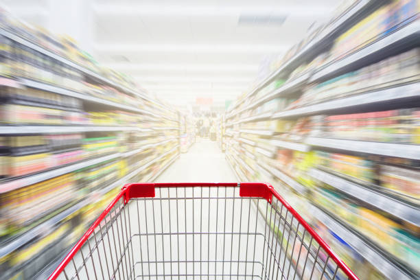 istock Supermarket aisle with empty red shopping cart 648662610